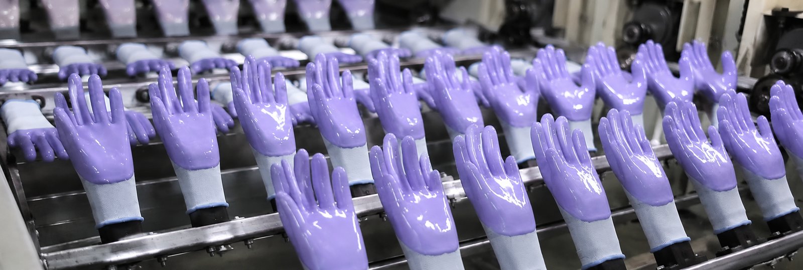 Purple NBR-coated work gloves on a production line