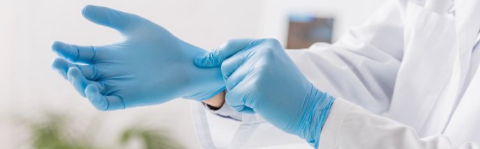 Putting on blue disposable NBR gloves