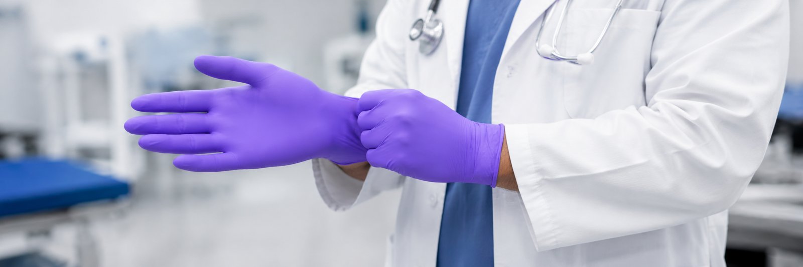 Putting on purple disposable NBR gloves
